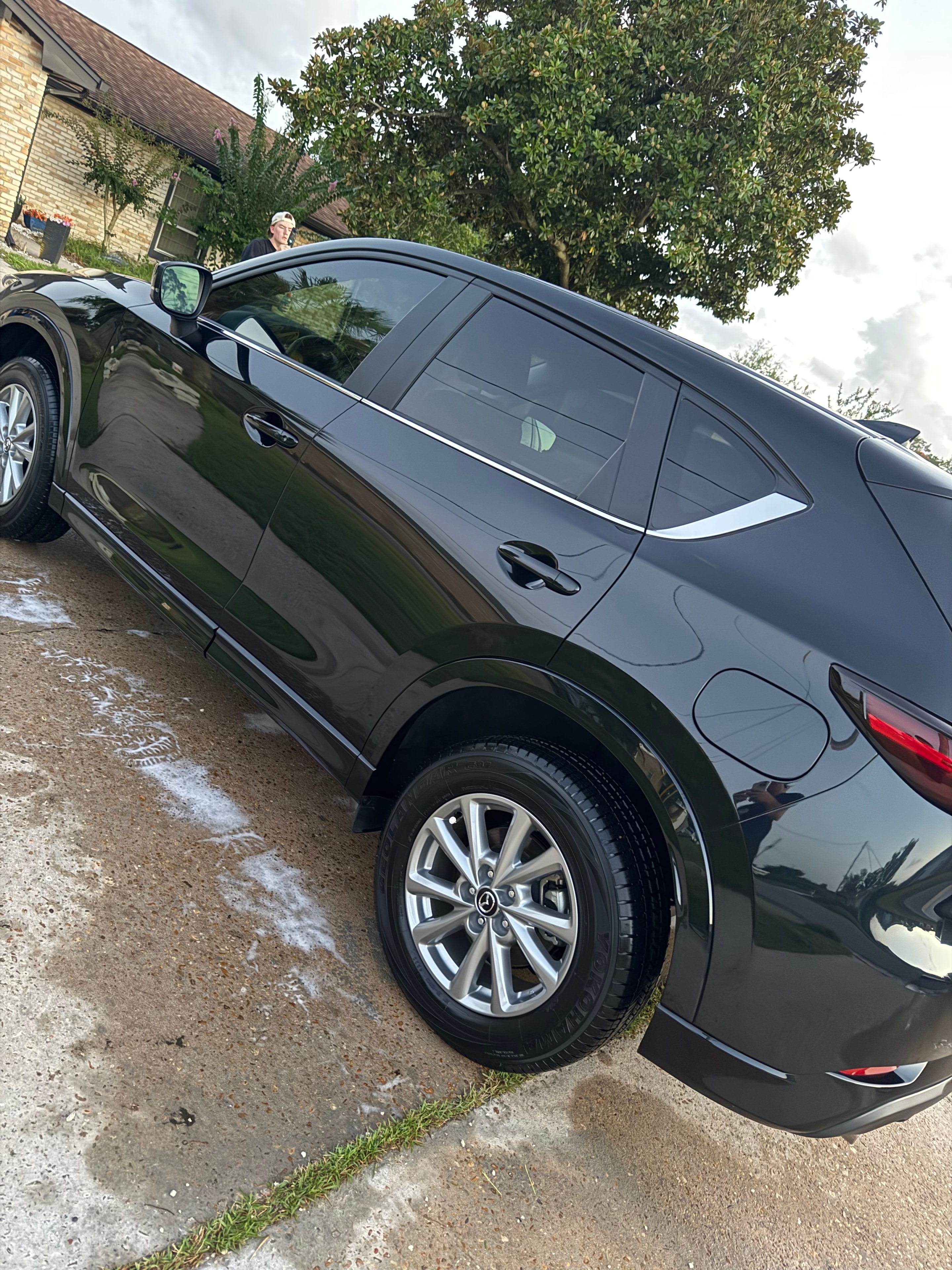 Dark SUV receiving foam wash detail service