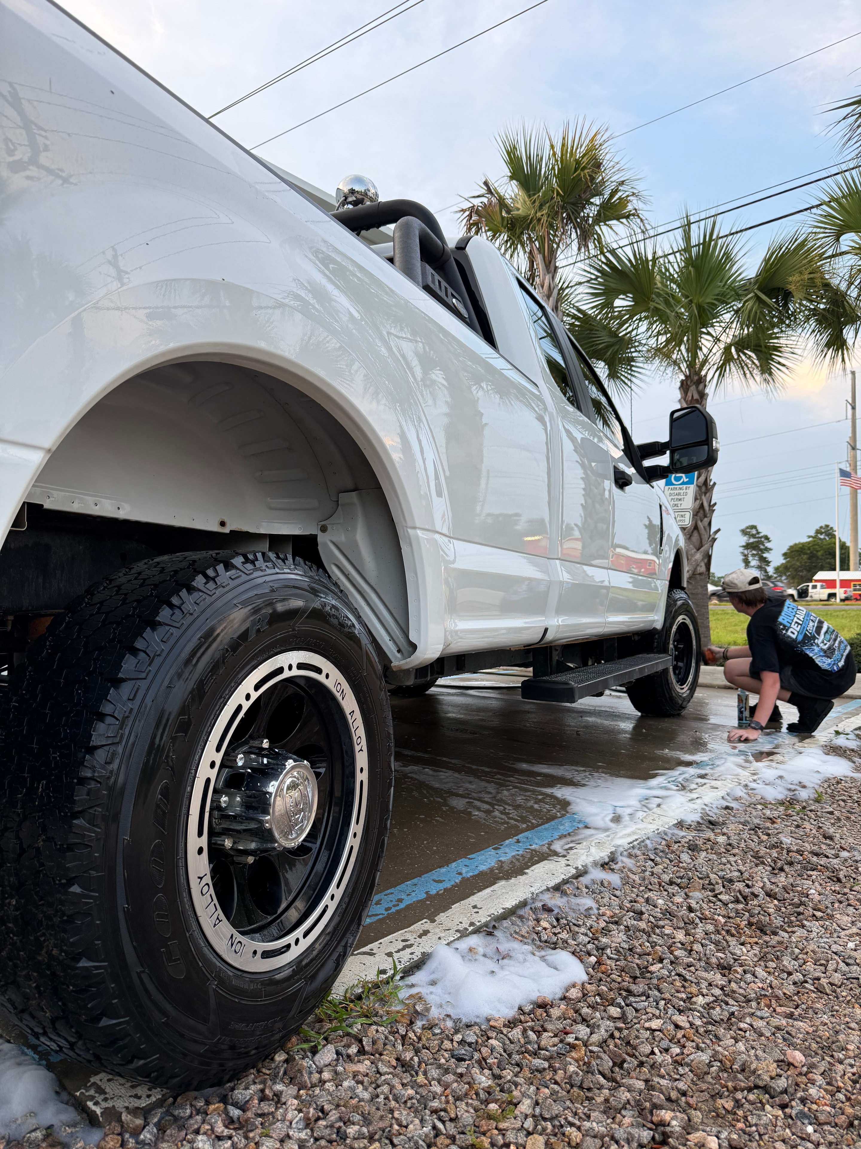 White truck with custom Ion Alloy wheels being detailed